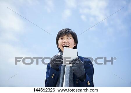 Happy Japanese teenager outdoors View Large Photo Image Stock Photograph - Happy Japanese teenager outdoors. Fotosearch