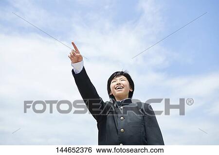 Stock Photograph - Happy Japanese teenager outdoors. Fotosearch