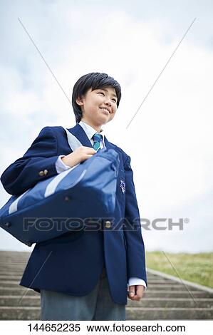 Stock Photography - Happy Japanese teenager outdoors. Fotosearch