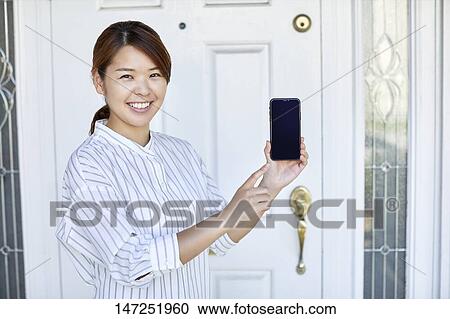 Happy Japanese woman at home View Large Photo Image Stock Image - Happy Japanese woman at home. Fotosearch