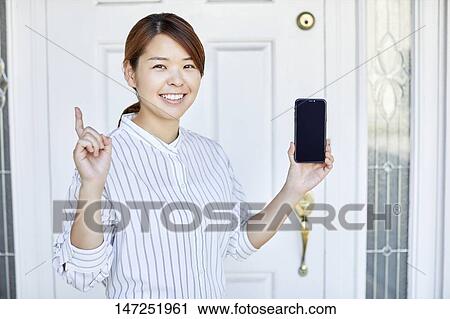 Happy Japanese woman at home View Large Photo Image Stock Image - Happy Japanese woman at home. Fotosearch