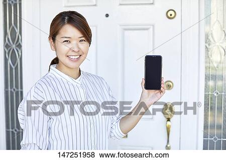 Happy Japanese woman at home View Large Photo Image Stock Photo - Happy Japanese woman at home. Fotosearch