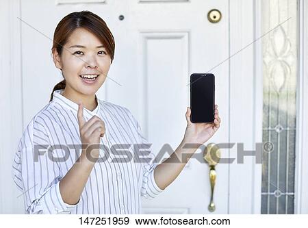 Happy Japanese woman at home View Large Photo Image Stock Photo - Happy Japanese woman at home. Fotosearch
