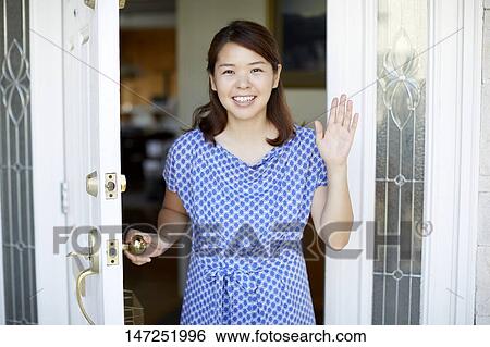 Stock Photograph - Happy Japanese woman at home. Fotosearch