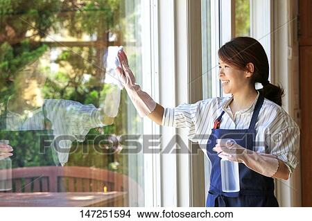 Happy Japanese woman cleaning windows at home View Large Photo Image Picture - Happy Japanese woman cleaning windows at home. Fotosearch
