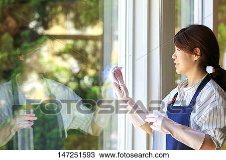 Happy Japanese woman cleaning windows at home View Large Photo Image Stock Image - Happy Japanese woman cleaning windows at home. Fotosearch