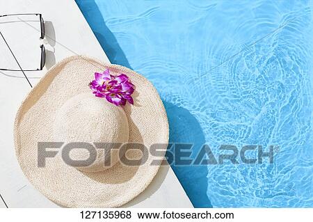 Stock Photo - Hat At The Poolside. Fotosearch