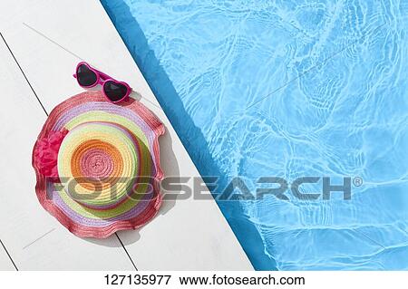 Stock Photo - Hat At The Poolside. Fotosearch