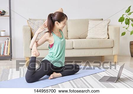 Stock Image - Healthy Japanese woman training at home. Fotosearch