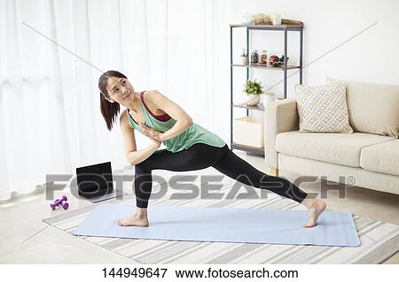 Stock Photo - Healthy Japanese woman training at home. Fotosearch