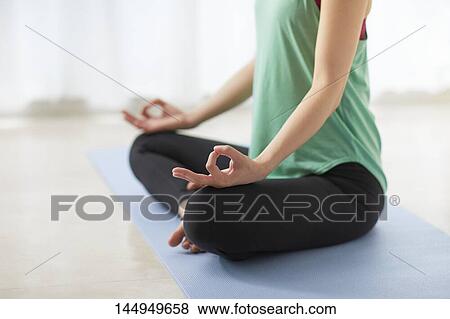Stock Photo - Healthy Japanese woman training at home. Fotosearch