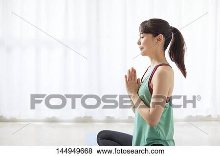 Stock Photo - Healthy Japanese woman training at home. Fotosearch