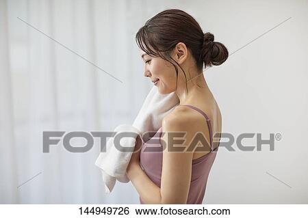 Stock Photograph - Healthy Japanese woman training at home. Fotosearch