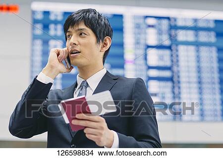 Picture - Japanese businessman at the airport. Fotosearch