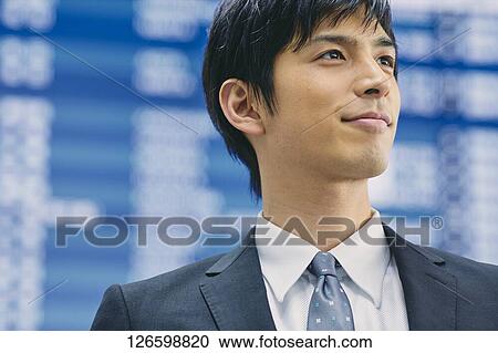 Stock Image - Japanese businessman at the airport. Fotosearch