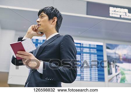 Stock Image - Japanese businessman at the airport. Fotosearch