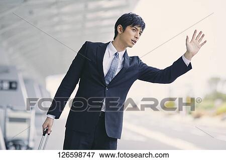 Stock Photo - Japanese businessman at the airport. Fotosearch