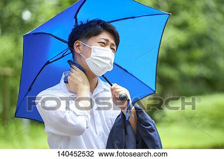Stock Image - Japanese Businessman Wiping Off The Sweat With Handkerchief. Fotosearch