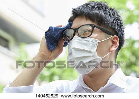 Stock Photo - Japanese Businessman Wiping Off The Sweat With Handkerchief. Fotosearch