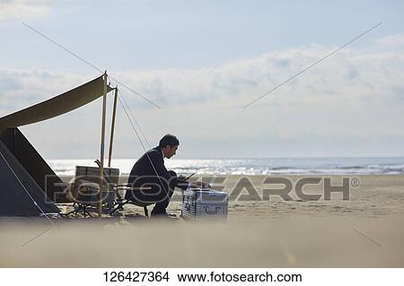 Japanese businessman working at the beach View Large Photo Image Picture - Japanese businessman working at the beach. Fotosearch