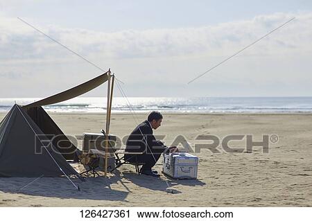 Japanese businessman working at the beach View Large Photo Image Stock Image - Japanese businessman working at the beach. Fotosearch