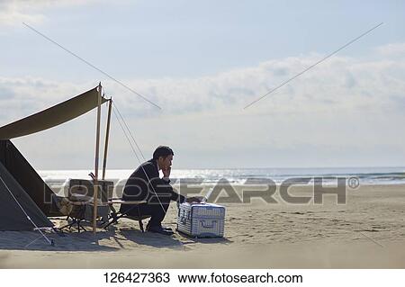 Japanese businessman working at the beach View Large Photo Image Stock Image - Japanese businessman working at the beach. Fotosearch
