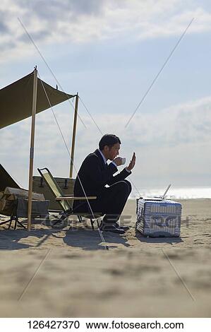 Japanese businessman working at the beach View Large Photo Image Stock Image - Japanese businessman working at the beach. Fotosearch