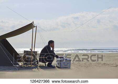 Japanese businessman working at the beach View Large Photo Image Stock Photograph - Japanese businessman working at the beach. Fotosearch