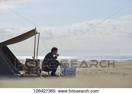 Japanese businessman working at the beach View Large Photo Image Stock Photography - Japanese businessman working at the beach. Fotosearch