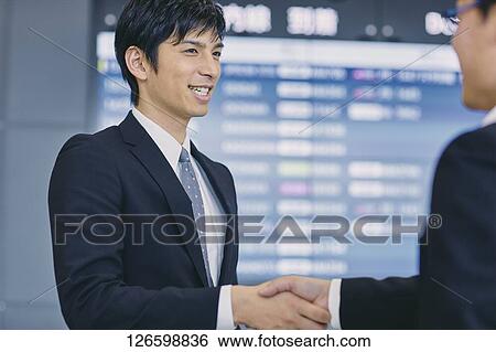 Stock Photograph - Japanese businessmen at the airport. Fotosearch