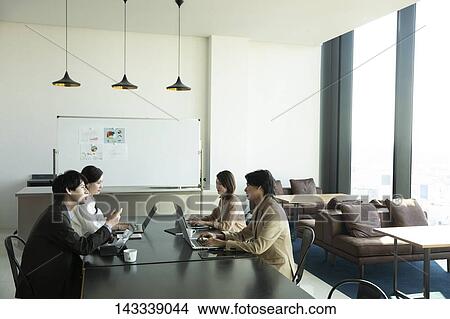 Picture - Japanese businesspeople in the office. Fotosearch