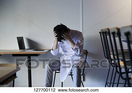 Stock Image - Japanese Chef Depressed In His Restaurant. Fotosearch