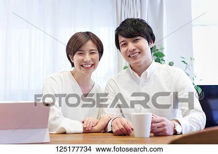 Picture - Japanese couple at home. Fotosearch
