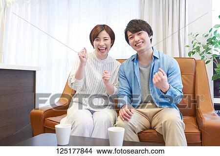 Picture - Japanese couple at home. Fotosearch