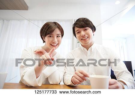 Stock Image - Japanese couple at home. Fotosearch