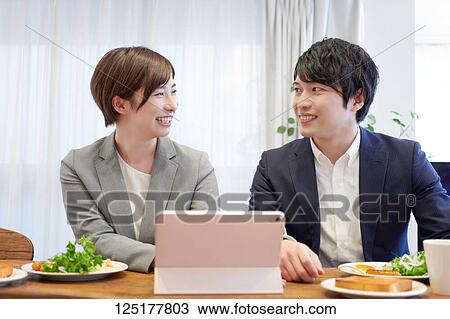 Stock Image - Japanese couple at home. Fotosearch