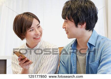 Stock Image - Japanese couple at home. Fotosearch
