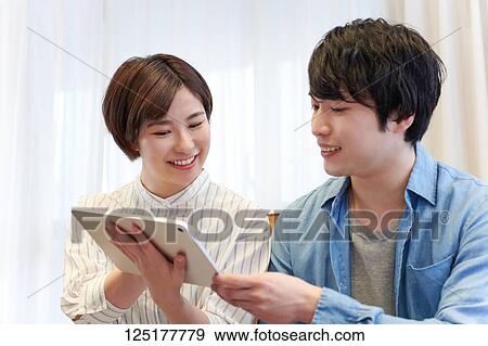 Stock Photo - Japanese couple at home. Fotosearch