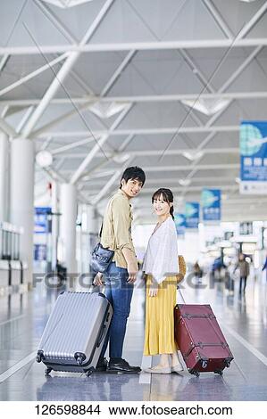 Japanese couple at the airport View Large Photo Image Picture - Japanese couple at the airport. Fotosearch
