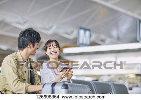 Japanese couple at the airport View Large Photo Image Picture - Japanese couple at the airport. Fotosearch