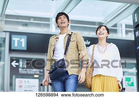 Japanese couple at the airport View Large Photo Image Picture - Japanese couple at the airport. Fotosearch