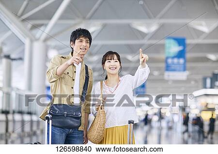 Japanese couple at the airport View Large Photo Image Stock Image - Japanese couple at the airport. Fotosearch