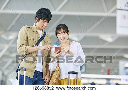 Japanese couple at the airport View Large Photo Image Stock Image - Japanese couple at the airport. Fotosearch