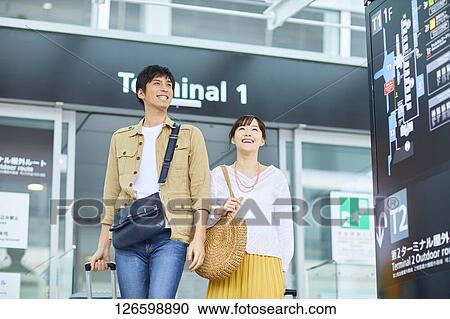 Japanese couple at the airport View Large Photo Image Stock Image - Japanese couple at the airport. Fotosearch