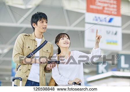 Japanese couple at the airport View Large Photo Image Stock Photo - Japanese couple at the airport. Fotosearch
