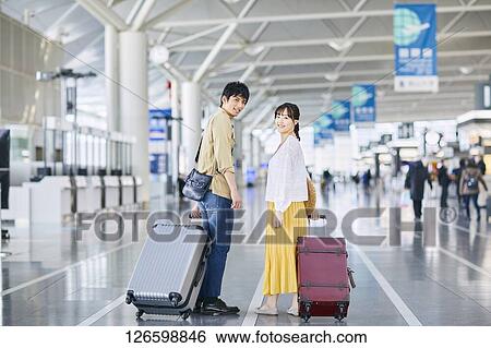 Stock Photograph - Japanese couple at the airport. Fotosearch