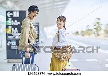 Stock Photograph - Japanese couple at the airport. Fotosearch
