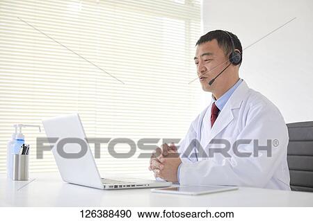 Stock Image - Japanese doctor in the studio. Fotosearch
