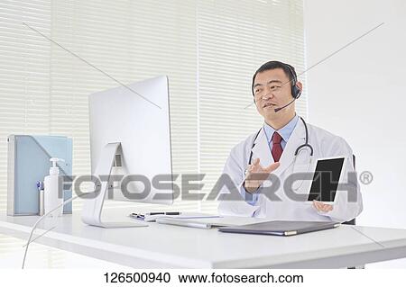 Stock Image - Japanese doctor in the studio. Fotosearch