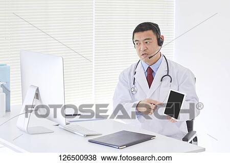 Stock Photo - Japanese doctor in the studio. Fotosearch